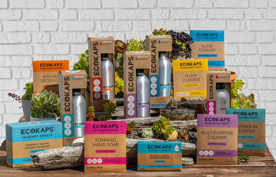 All ECOKAPS products on a wooden surface with a white brick wall background.